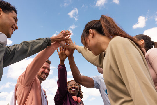 Multiethnic friends celebrating outdoor workout success