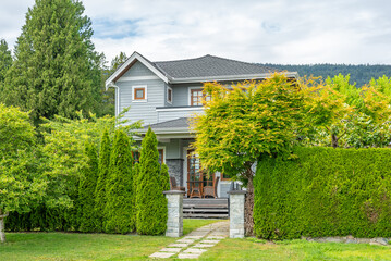 Entrance of painted luxury house in spring with stair steps and nice landscape in Vancouver, Canada, North America. Day time on May 2025.