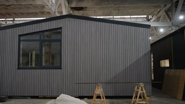 Modular house under construction in a large warehouse