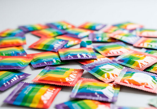 Colorful rainbow condom packaging for diversity campaigns, LGBTQ+ health awareness or inclusive relationship visuals - Powered by Adobe