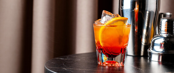 Bicicletta cocktail served with dry white wine, Italian bitter, and vibrant orange slices at a...