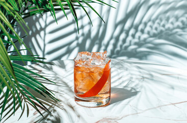 Refreshing cocktail with vodka aquavit and grapefruit twist served in a trendy bar lounge setting