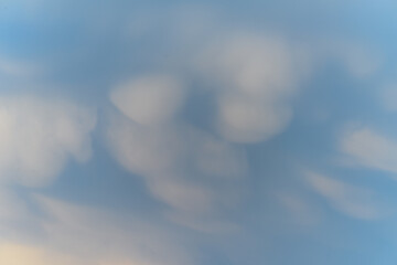 Unique cloud formations display dramatic textures during sunset over the landscape