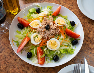 Delicious salad with canned tuna, boiled eggs and fresh tomatoes