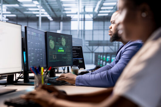 System administrator receiving access granted notification while reconfiguring server farm, optimizing it. IT specialist ensures data center operates efficiently, successfully eliminating all errors