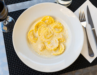 Delicious italian ravioli with cheese served in sauce on platter