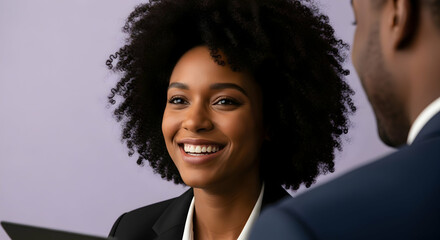 Smiling african american businesswoman in a meeting looking at colleague professional conversation