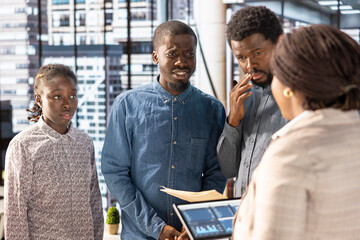Professional team analyzing archived data on a modern device, collaborating on enterprise solutions...