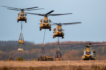 US Army military heavy-lift transport helicopter operation with slingloads. 