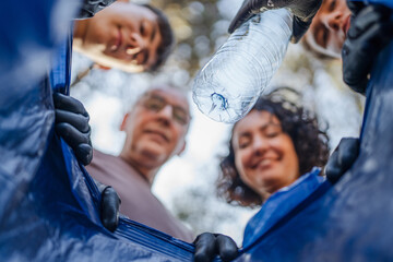 Point of view from inside of bag of family collect plastic waste