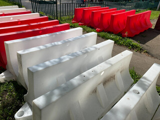 Red and white Plastic Traffic Barriers also called as  Jersey barriers. Temporary road plastic fencing.