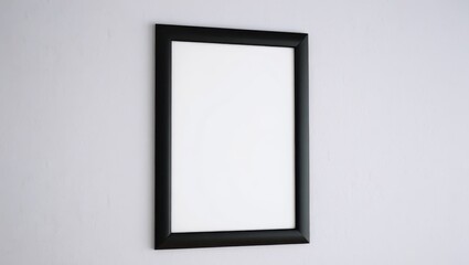 Empty black picture frame hanging on a textured white wall background