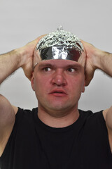 portrait of a man with  tinfoil hat