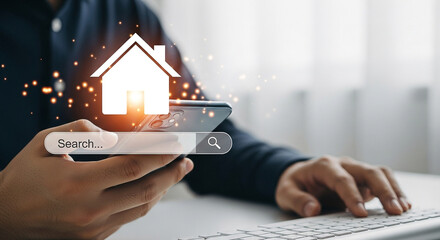 A person searches for a house online using a smartphone and laptop, symbolizing real estate