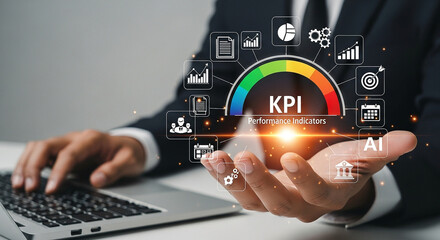 Businessman holding a kpi performance indicators gauge with various business icons