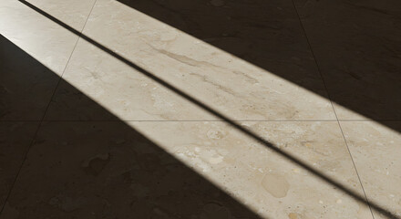 A stark diagonal stripe of natural sunlight and deep shadow falls across a textured light-colored tiled floor, creating a minimalist abstract pattern.
