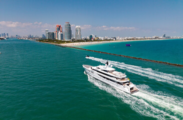 Aerial view of boats on turquoise waters in Miami. Yacht retreat in Miami. Oceanfront cityscape...
