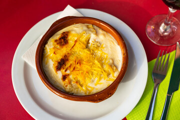 Delicious cannelloni stuffed with meat served with cheese on platter