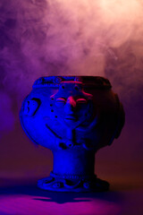 Ancestral pre-Columbian ceramic figure in an ethereal scene, surrounded by a spiritual atmosphere