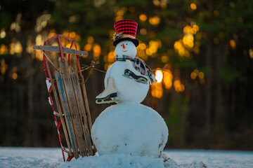 Snowman on snow background. Winter holiday scene. Snowman with scarf and hat. Snow design. Happy snowman outdoor. Snow banner. Frosty snowman. Winter greeting card. Cute snow man. Winter holiday.