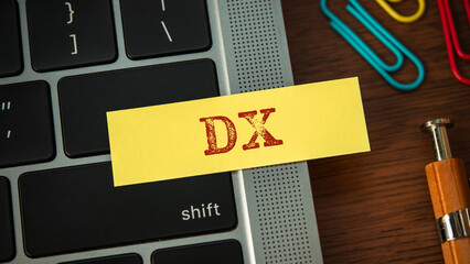 There is sticky note with the word DX. It is an abbreviation for Digital Transformation as eye-catching image.