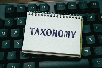 There is notebook with the word Taxonomy. It is as an eye-catching image.