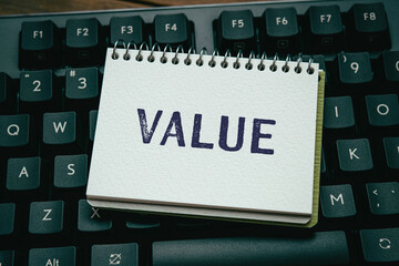 There is notebook with the word VALUE. It is as an eye-catching image.