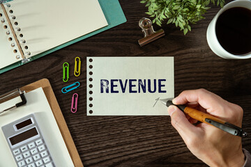 There is a piece of paper with the word Revenue. It is as an eye-catching image.