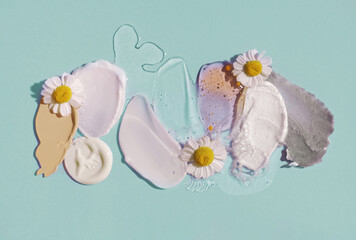 Korean method swatch set cosmetic product texture palette with daisy on blue isolated background