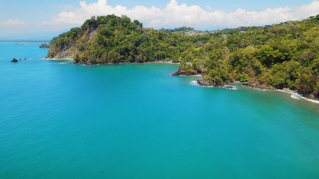 Turquoise coastal waters meet lush cliffs and hidden beaches in Costa Rica