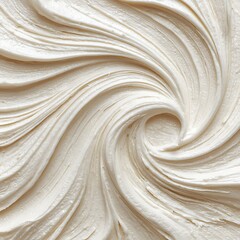 The spiral pattern of white cream on a clean surface is a minimalist image that can be used as a background for various product advertisements.