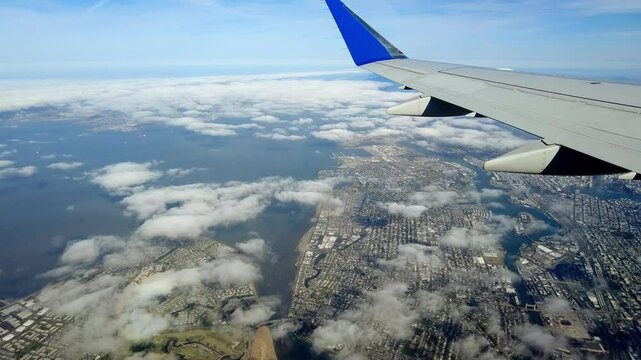 Aerial view from an airplane flying over Oakland and Alameda, California along the Pacific Coast.