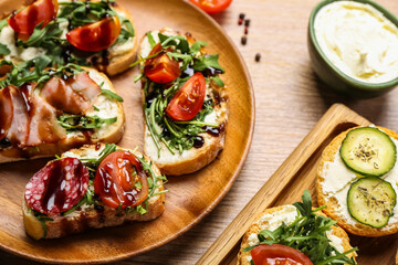 Plate with tasty sandwiches on wooden table, closeup
