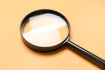 Black magnifier on orange background