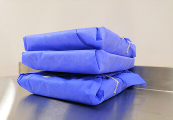 Blue Wrapped Sterile Surgical Instrument Packs on Table in Hospital Setting