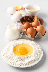 Composition with different ingredients for preparing bakery on light background, closeup