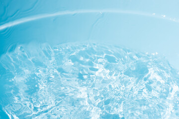 Blue water with ripples on the surface. Defocus blurred transparent blue colored clear calm water...