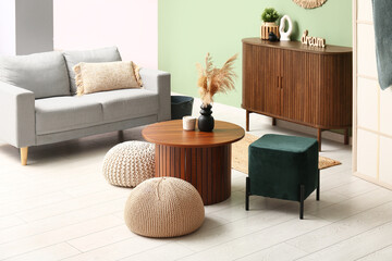 Interior of modern living room with coffee table and poufs