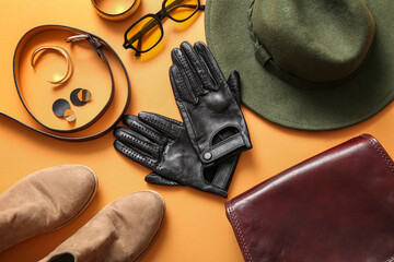 Composition with black leather gloves, female accessories and shoes on color background