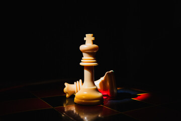 Chess pieces on a red and black board with black background