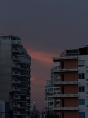 Modern sky rises during a purple sunset. Distrito Nacional, Santo Domingo, Dominican Republic