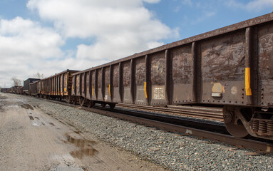 Fototapeta premium An open cargo train car on the railway.