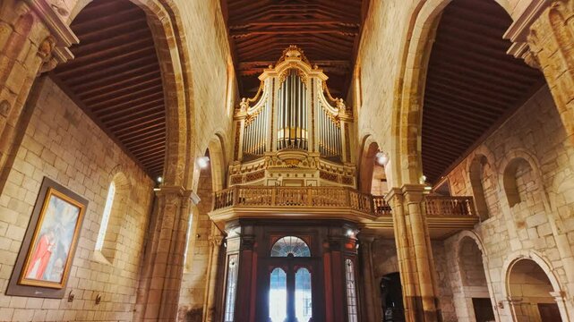 Vaulted nave of Interior of Igreja de Nossa Senhora da Oliveira Church houses baroque retables carved choir stalls in Guimaraes, Portugal