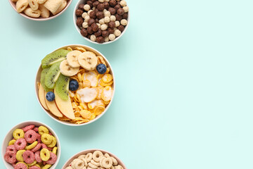 Different healthy cereal bowls with fresh fruits on blue background