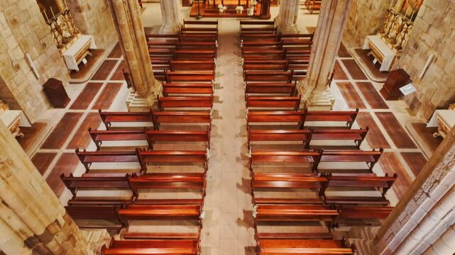 Interior of Igreja de Nossa Senhora da Oliveira Church reveals soaring granite pillars gilded altars and stained glass in Guimaraes, Portugal