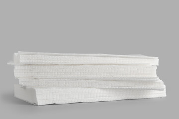 Stack of paper napkins on grey background