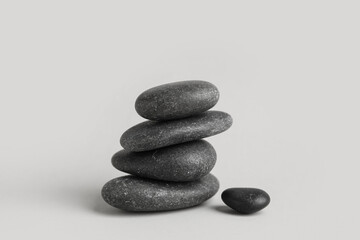 Many black pebbles on grey background