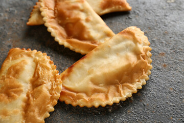 Tasty chebureks on grey grunge table