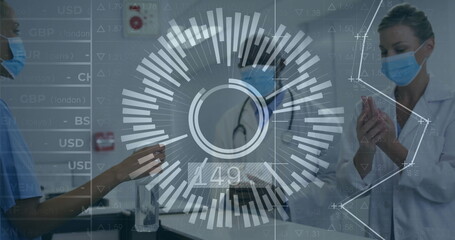 Three masked professionals sanitizing hands in hospital with sanitizer dispenser and stethoscope