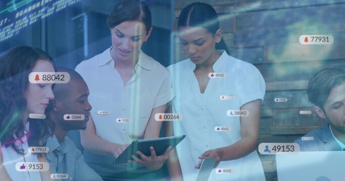 Collaborating colleagues reviewing project on tablet in conference room, with notification icons